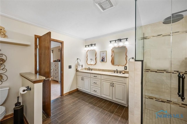 6681 Bellflower Ct, Curtice, OH 43412 - full bath featuring toilet, a stall shower, ornamental molding, wood finished floors, and double vanity