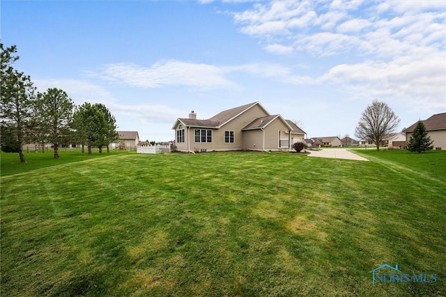 6681 Bellflower Ct, Curtice, OH 43412 - rear view of property with a lawn and a chimney