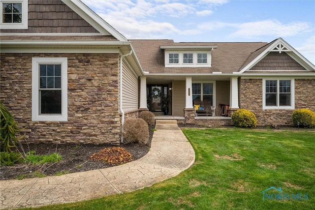 6681 Bellflower Ct, Curtice, OH 43412 - view of front of property featuring stone siding, a porch, a front yard, and roof with shingles