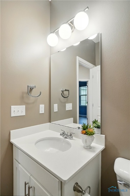 bathroom featuring vanity and toilet