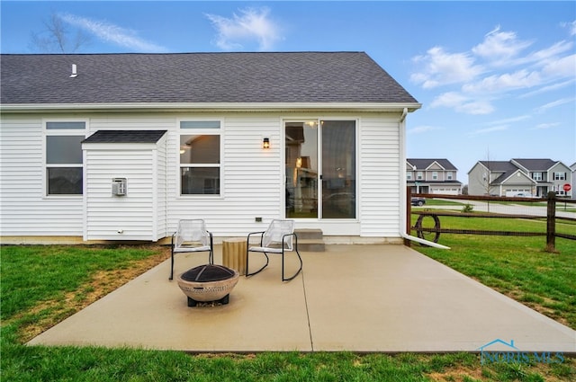back of house with a patio, a fire pit, a yard, fence, and a shingled roof