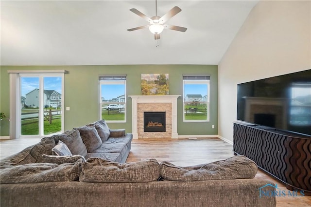 living room featuring ceiling fan, plenty of natural light, and wood finished floors