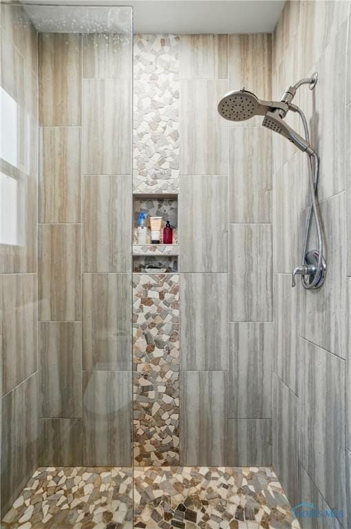 full bathroom with tiled shower