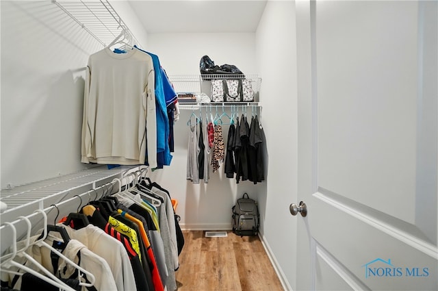 spacious closet with wood finished floors and visible vents