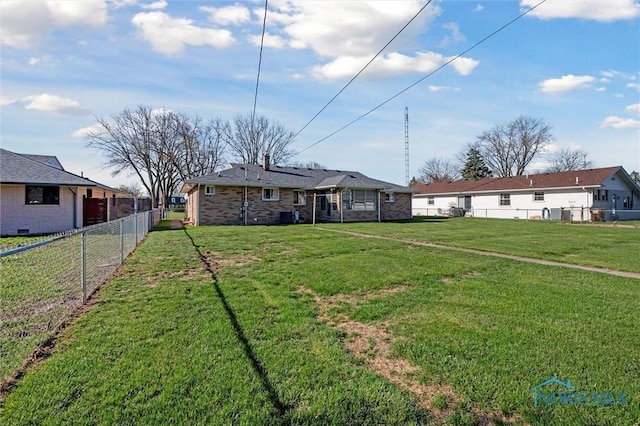 2931 Jasik Dr, Toledo, OH 43611 - exterior space featuring a front yard, brick siding, and a fenced backyard