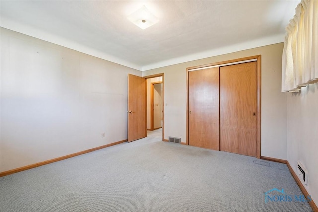 2931 Jasik Dr, Toledo, OH 43611 - unfurnished bedroom featuring light carpet, a closet, baseboards, and visible vents
