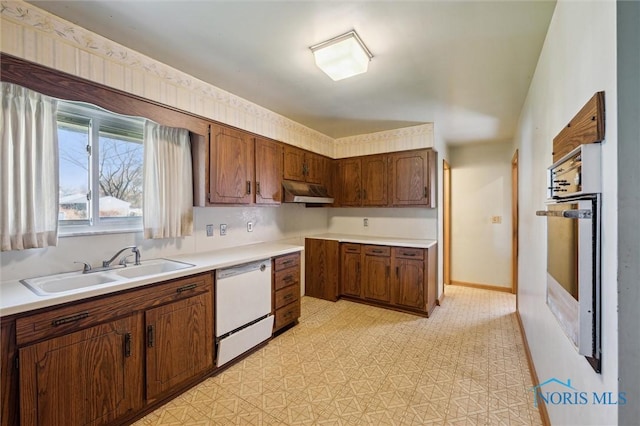 2931 Jasik Dr, Toledo, OH 43611 - kitchen with stainless steel oven, under cabinet range hood, a sink, light countertops, and white dishwasher
