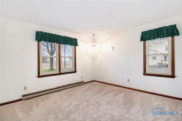 unfurnished room featuring plenty of natural light, baseboard heating, baseboards, and carpet floors