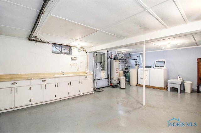 below grade area with a sink, washer and clothes dryer, and gas water heater