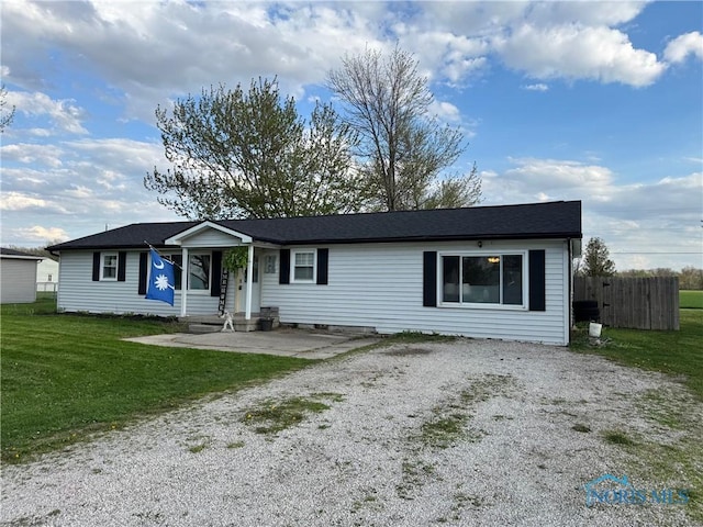 single story home featuring fence, driveway, and a front yard
