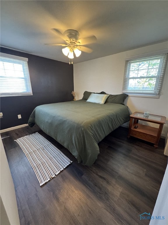 bedroom with wood finished floors and a ceiling fan