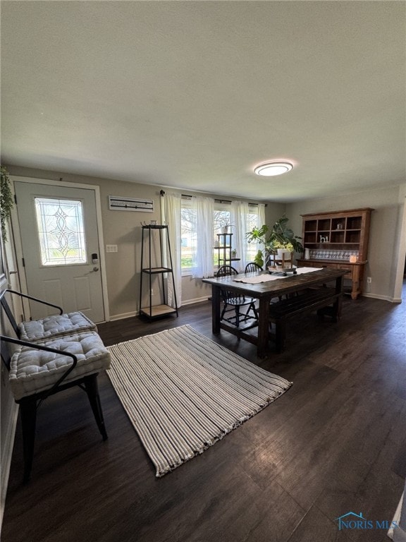 living room featuring dark wood-style flooring and baseboards