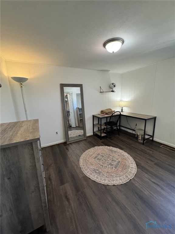 dining space featuring wood finished floors and baseboards