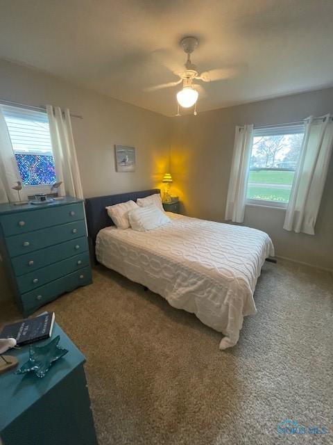 carpeted bedroom with a ceiling fan