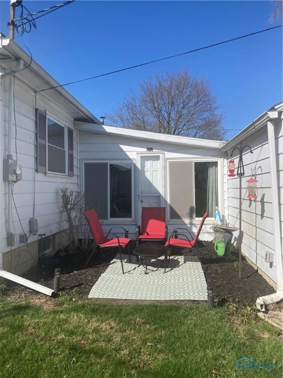 back of property with a patio
