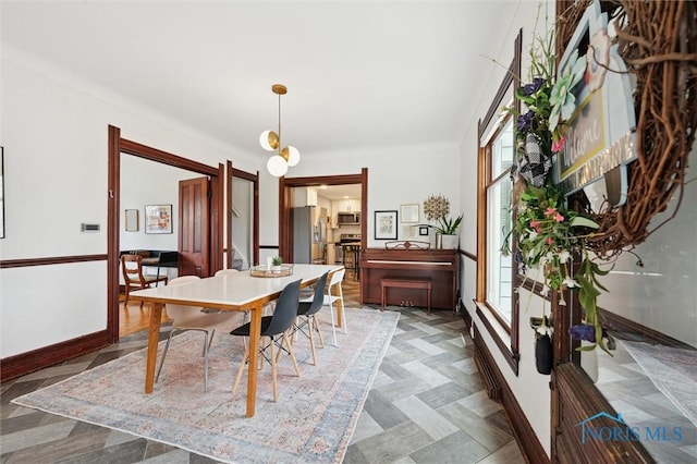 dining area featuring baseboards
