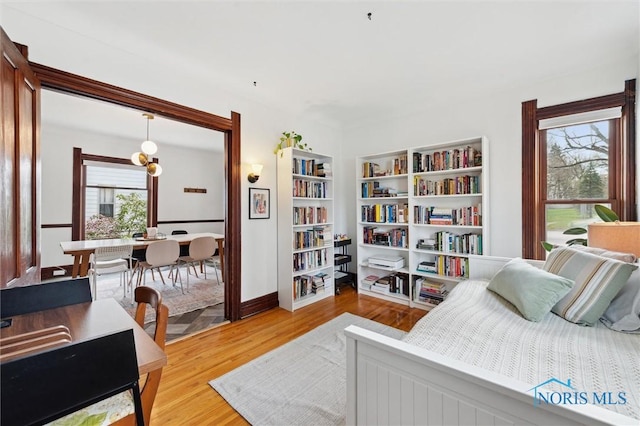 bedroom with wood finished floors and baseboards