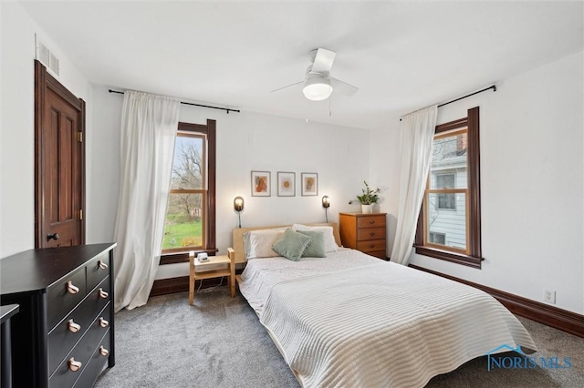 bedroom with baseboards, a ceiling fan, visible vents, and carpet floors