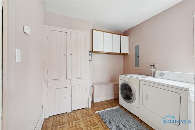 laundry room with cabinet space, washing machine and clothes dryer, and electric panel