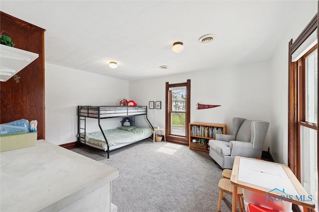 carpeted bedroom featuring visible vents
