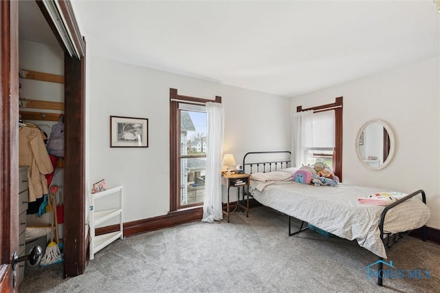 bedroom featuring carpet and baseboards