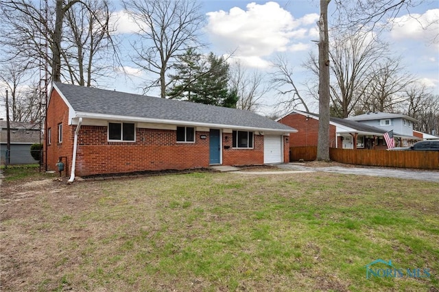 ranch-style house featuring driveway, fence, a front lawn, and brick siding