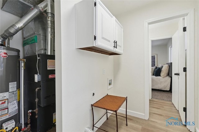 utility room featuring gas water heater
