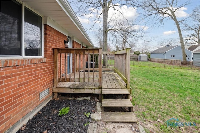 wooden deck with a yard and fence