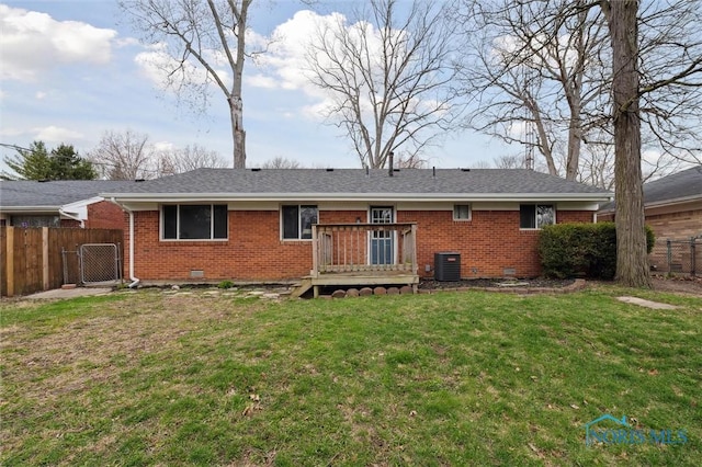 back of house featuring central AC unit, a deck, crawl space, fence, and brick siding