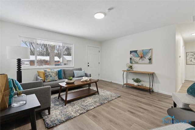 living room featuring baseboards and wood finished floors