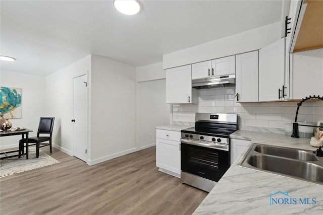kitchen with backsplash, white cabinets, under cabinet range hood, light wood-style floors, and electric stove
