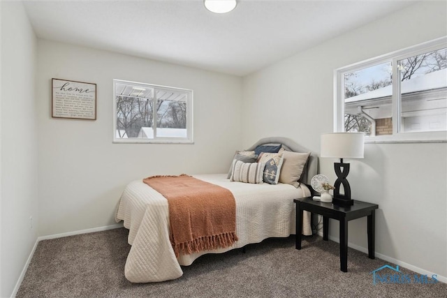 carpeted bedroom featuring baseboards