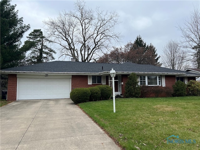 ranch-style house with a chimney, driveway, a front lawn, brick siding, and a garage
