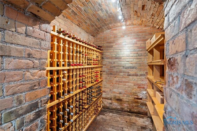 1 S Saint Clair St, Toledo, OH 43604 - wine area featuring brick floor, brick wall, brick ceiling, and vaulted ceiling