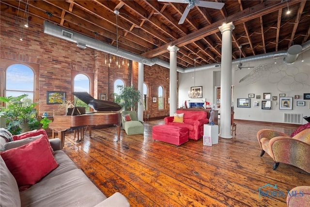 1 S Saint Clair St, Toledo, OH 43604 - living area with brick wall, visible vents, ornate columns, and ceiling fan