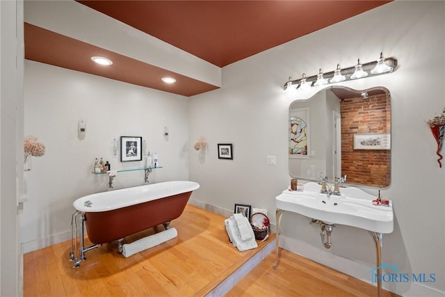 1 S Saint Clair St, Toledo, OH 43604 - full bath featuring wood finished floors, baseboards, and a freestanding tub