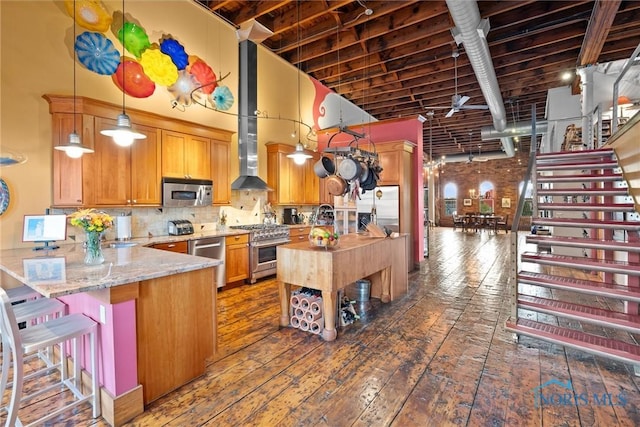 1 S Saint Clair St, Toledo, OH 43604 - kitchen featuring a peninsula, a high ceiling, hardwood / wood-style floors, stainless steel appliances, and pendant lighting
