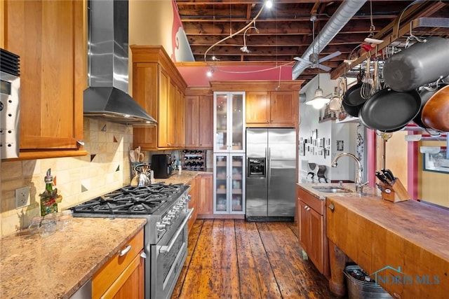 1 S Saint Clair St, Toledo, OH 43604 - kitchen with a sink, wall chimney range hood, dark wood-style flooring, appliances with stainless steel finishes, and brown cabinetry