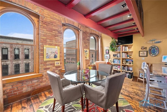 1 S Saint Clair St, Toledo, OH 43604 - dining area featuring wood-type flooring, plenty of natural light, beam ceiling, and brick wall