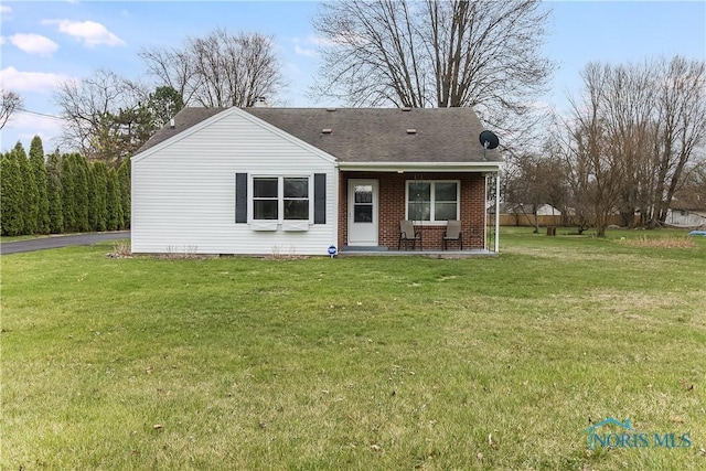 6939 Angola Rd, Holland, OH 43528 - view of front facade featuring a front yard, roof with shingles, and brick siding