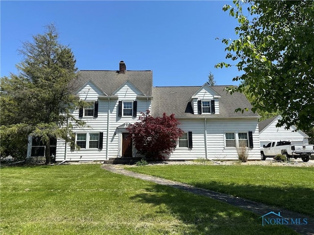 940 N Main St, Fostoria, OH 44830 - back of house with a yard, a chimney, and a shingled roof