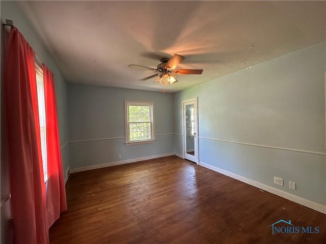 940 N Main St, Fostoria, OH 44830 - empty room with baseboards, dark wood finished floors, and a ceiling fan