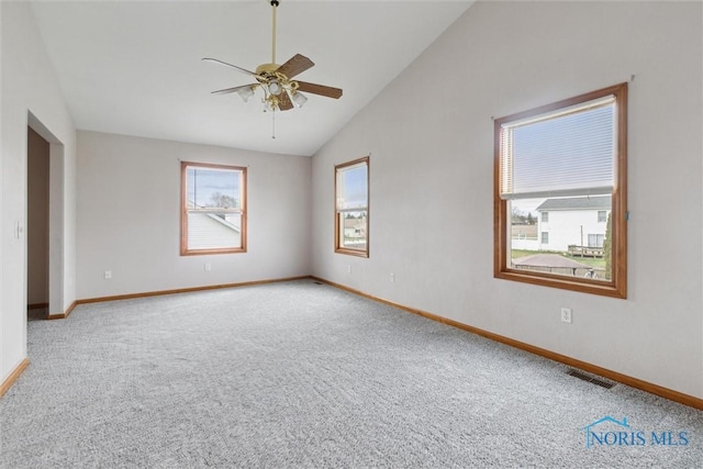 unfurnished room with visible vents, baseboards, ceiling fan, carpet flooring, and lofted ceiling