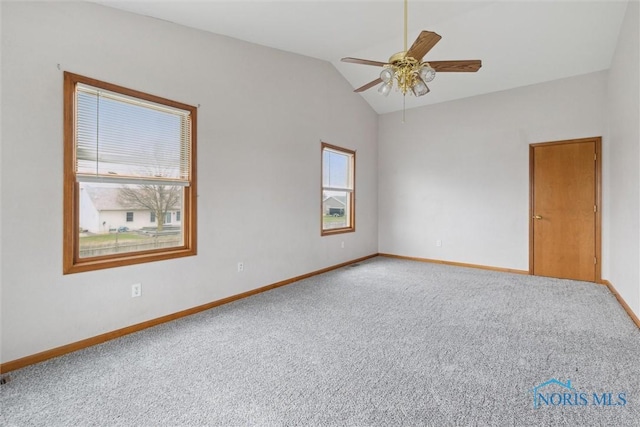 spare room featuring baseboards, a ceiling fan, lofted ceiling, and carpet floors