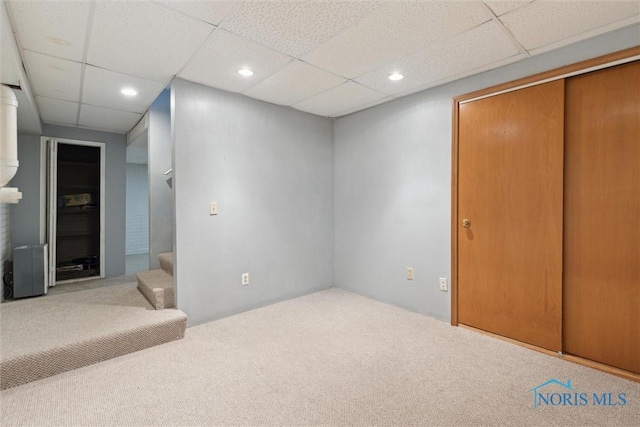 interior space with recessed lighting, a drop ceiling, and carpet floors