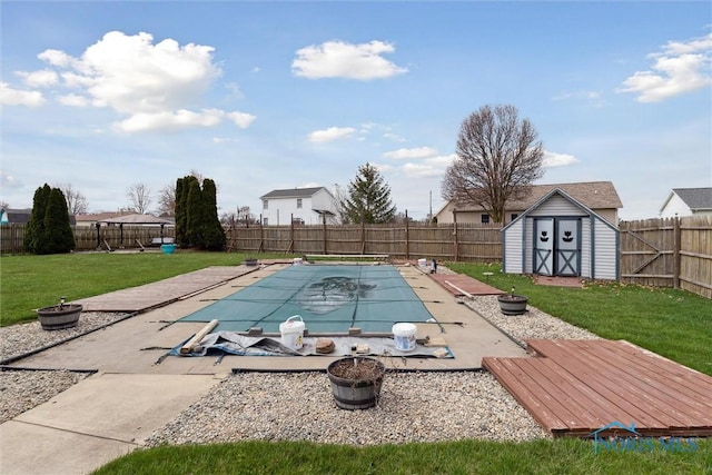 view of pool with a fenced backyard, a fenced in pool, a lawn, and a shed