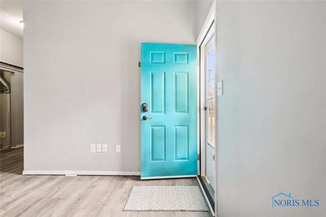 entrance foyer featuring baseboards and wood finished floors