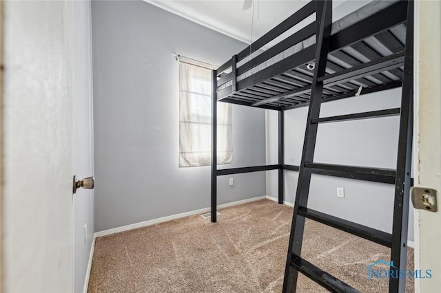 unfurnished bedroom featuring carpet floors and baseboards