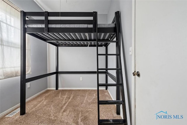unfurnished bedroom featuring carpet flooring, visible vents, and baseboards