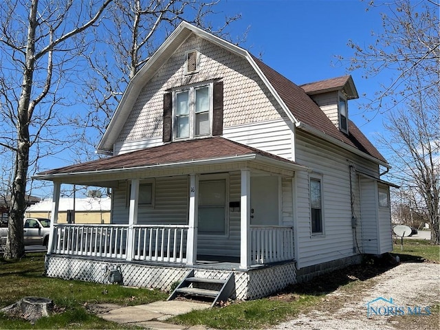16 College Pl, Defiance, OH 43512 - view of front facade with a porch, a gambrel roof, and roof with shingles